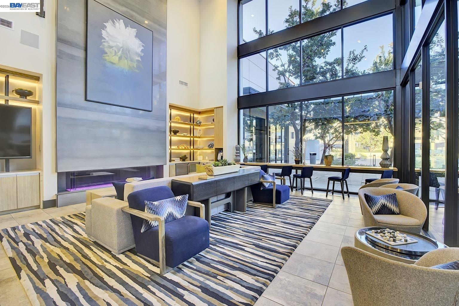 1748 Kilowatt Way, Unit 402 Fremont, CA 94539 - Photo 53 of 60 a living room with couches a coffee table and next to a large window