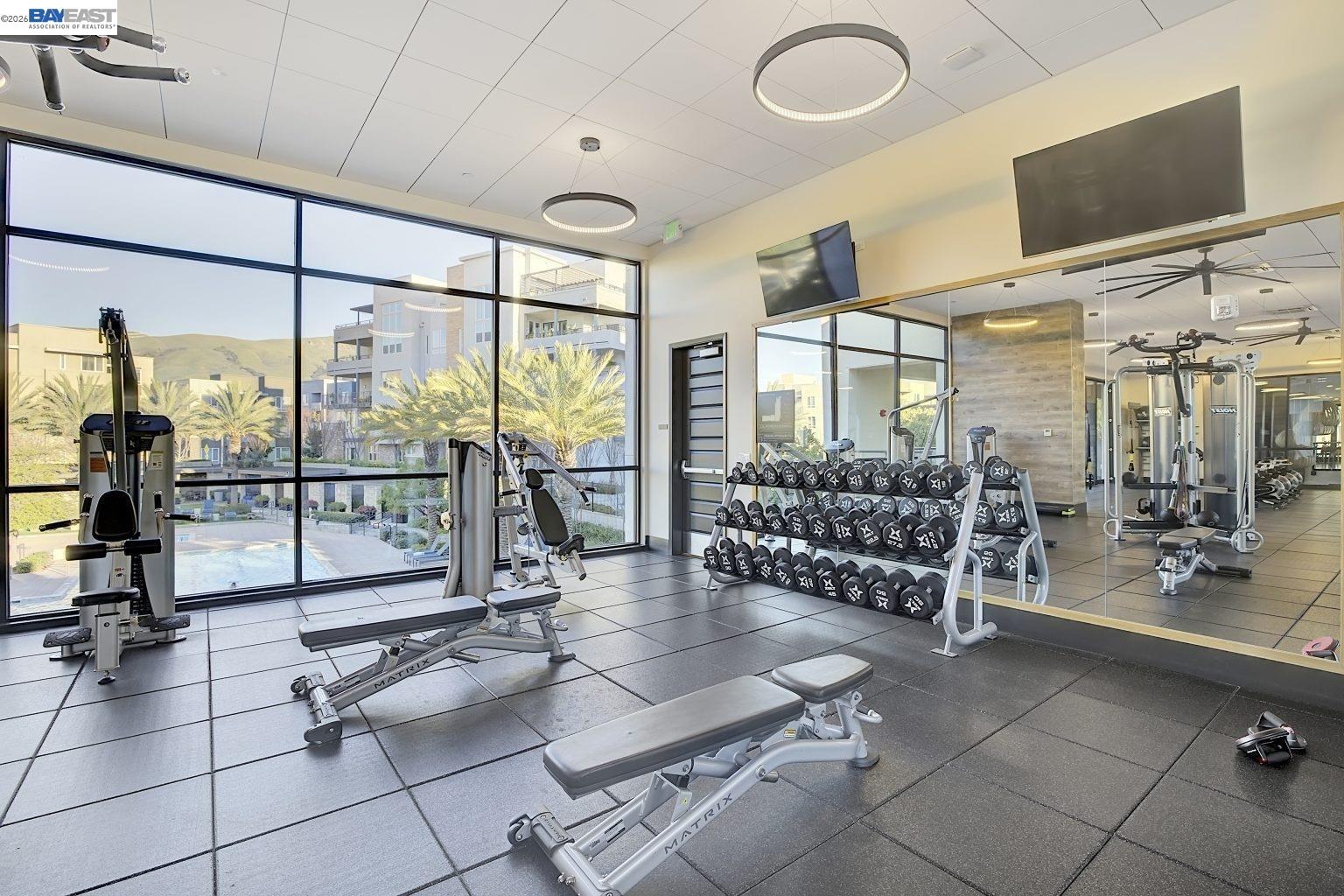 1748 Kilowatt Way, Unit 402 Fremont, CA 94539 - Photo 55 of 60 a room with gym equipment and large glass windows