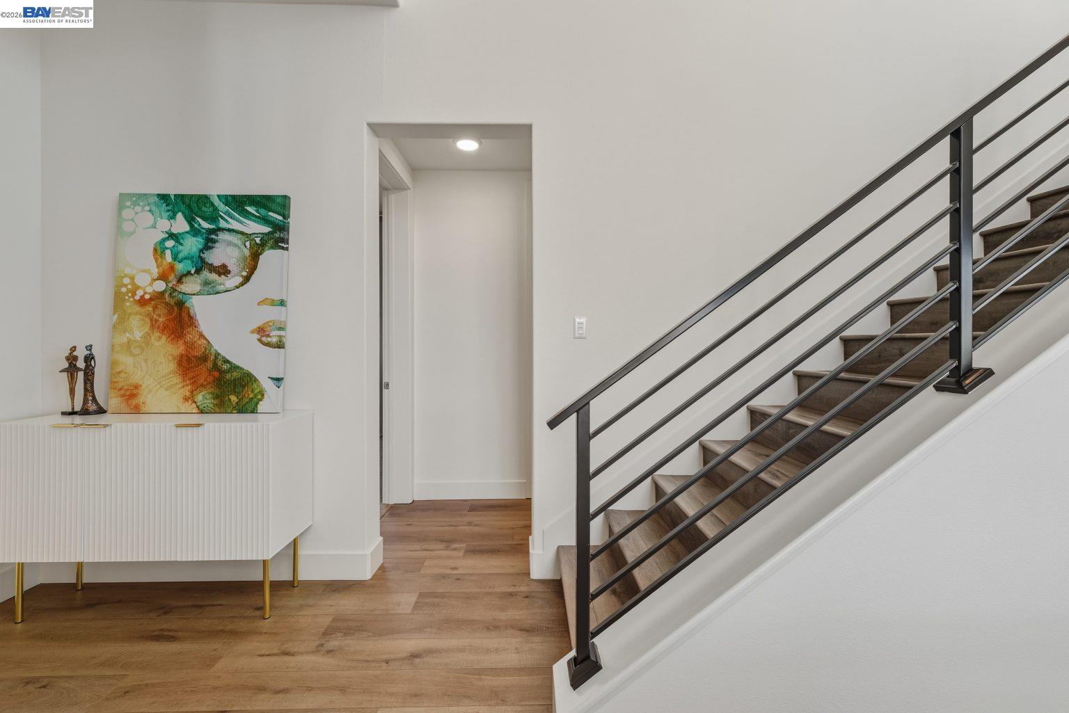 1748 Kilowatt Way, Unit 402 Fremont, CA 94539 - Photo 7 of 60 a view of a hallway with wooden floor and stairs