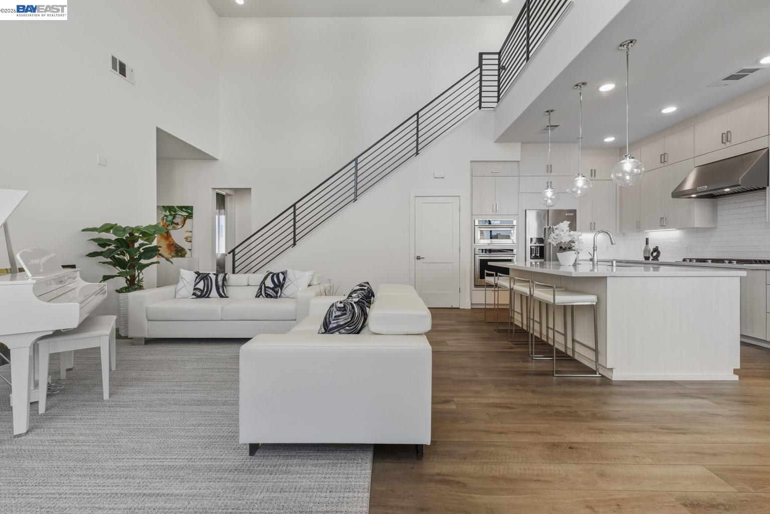 1748 Kilowatt Way, Unit 402 Fremont, CA 94539 - Photo 9 of 60 a living room with kitchen island furniture and a kitchen view