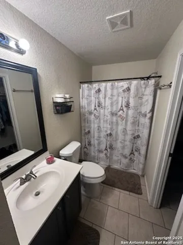 a bathroom with a sink and mirror with toilet