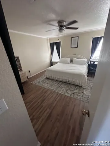 a bedroom with a bed and painting on the wall