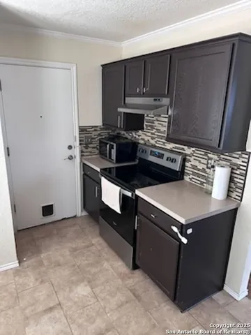 a kitchen with a stove microwave and sink