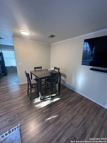 a room with wooden floor and furniture