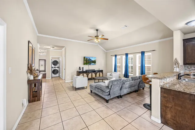a living room with furniture and a chandelier