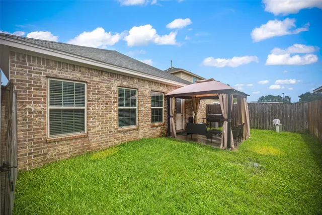 a view of a house with a yard and sitting area