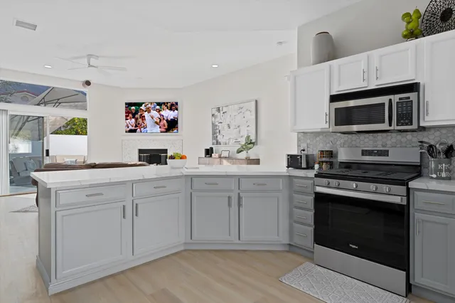 a kitchen with stainless steel appliances granite countertop a stove microwave and sink