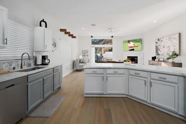 a kitchen with sink cabinets and wooden floor