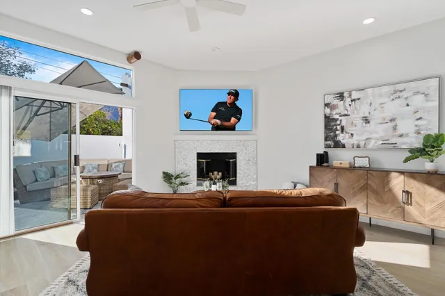 a living room with furniture a fireplace and a flat screen tv