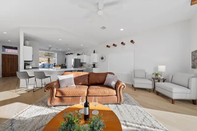 a living room with furniture and view of kitchen