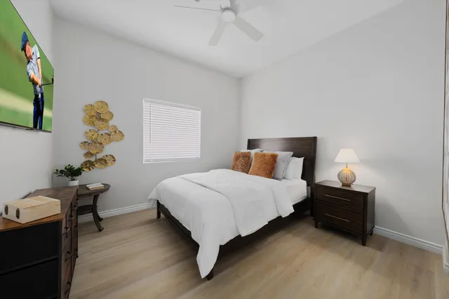 a bedroom with a bed and a potted plant