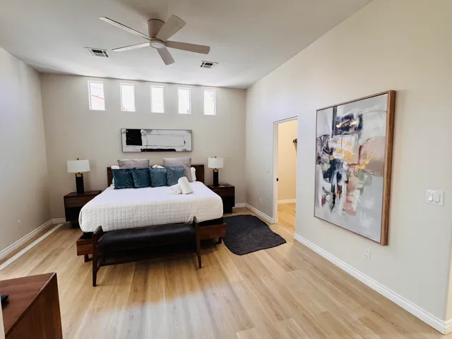 a bedroom with a bed and a wooden floor