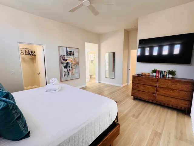 a bedroom with a bed and a flat screen tv