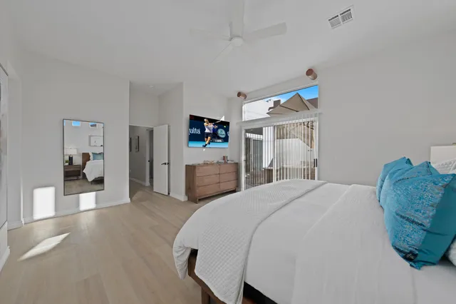 a bedroom with a bed and a view of kitchen