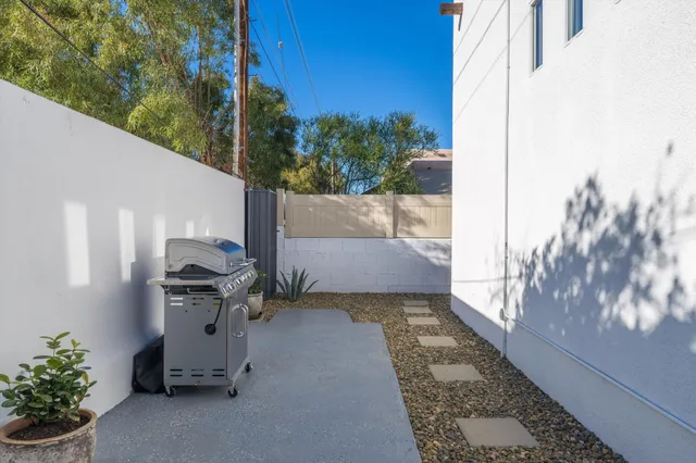 a view of a patio with table and chairs and potted plants