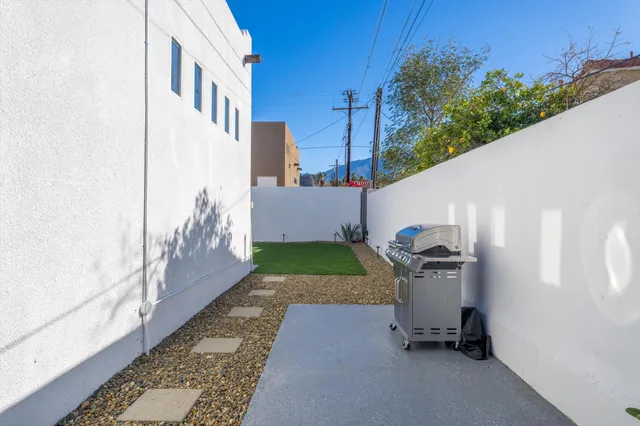 a view of a patio with a table and chairs