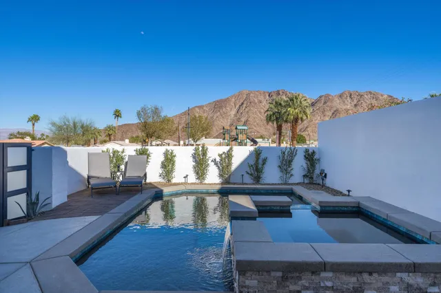 a view of a balcony with wooden floor and a floor to ceiling window