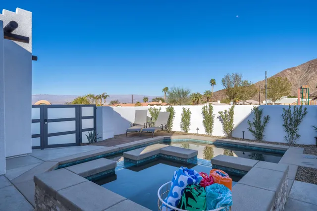 a view of a balcony with furniture and a potted plant