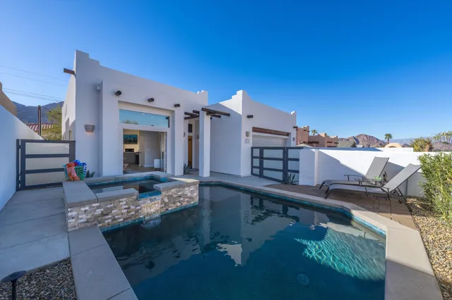 a view of a swimming pool with a lounge chairs