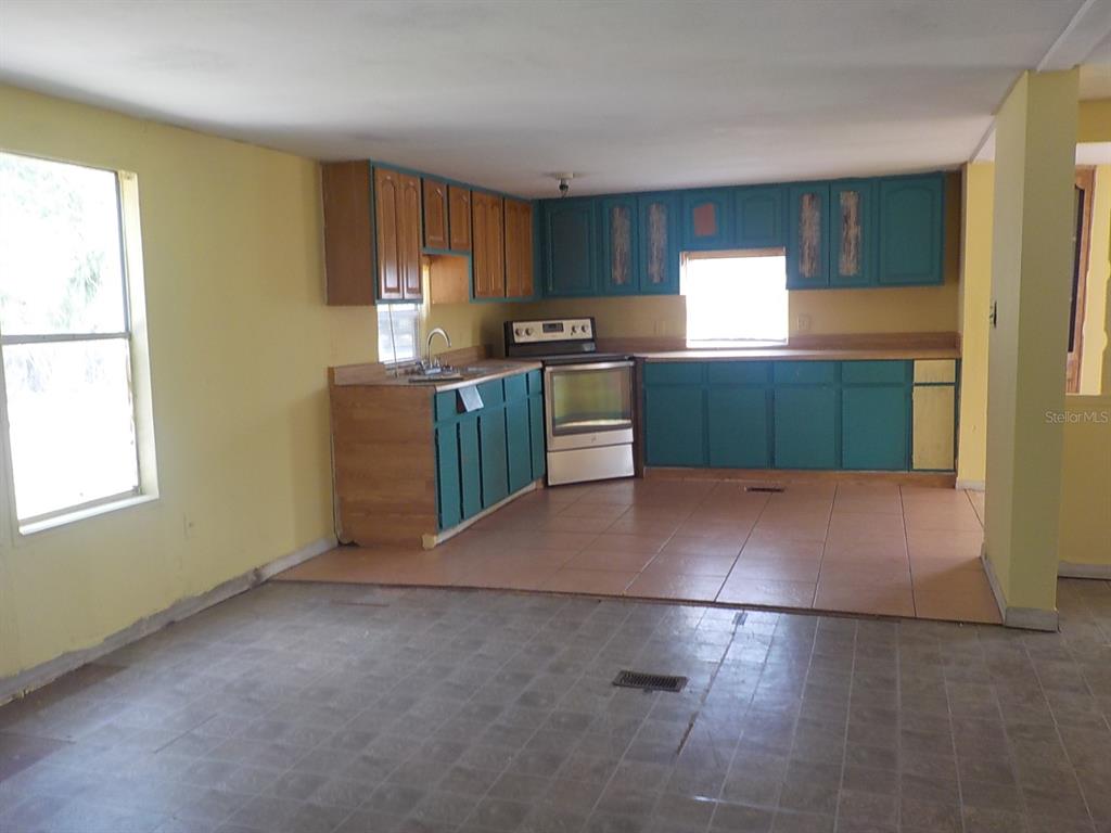 7445 Southwest 15th Place Ocala, FL 34474 - Photo 11 of 27 a kitchen with a cabinets and a stove top oven