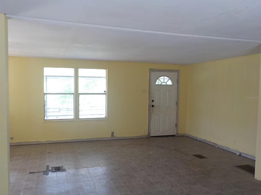 7445 Southwest 15th Place Ocala, FL 34474 - Photo 14 of 27 an empty room with windows