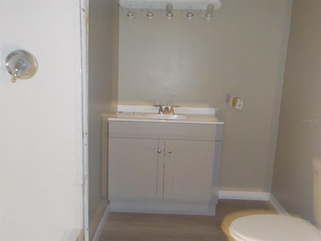 7445 Southwest 15th Place Ocala, FL 34474 - Photo 20 of 27 a bathroom with a sink a toilet and mirror