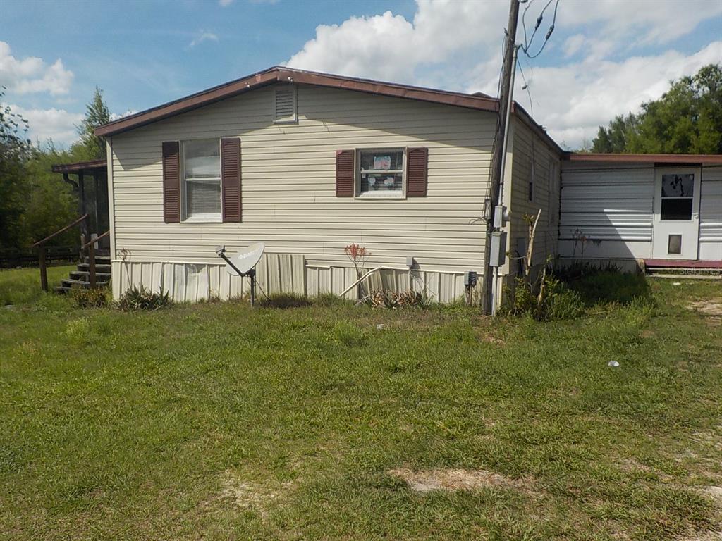 7445 Southwest 15th Place Ocala, FL 34474 - Photo 2 of 27 a house view with a garden space