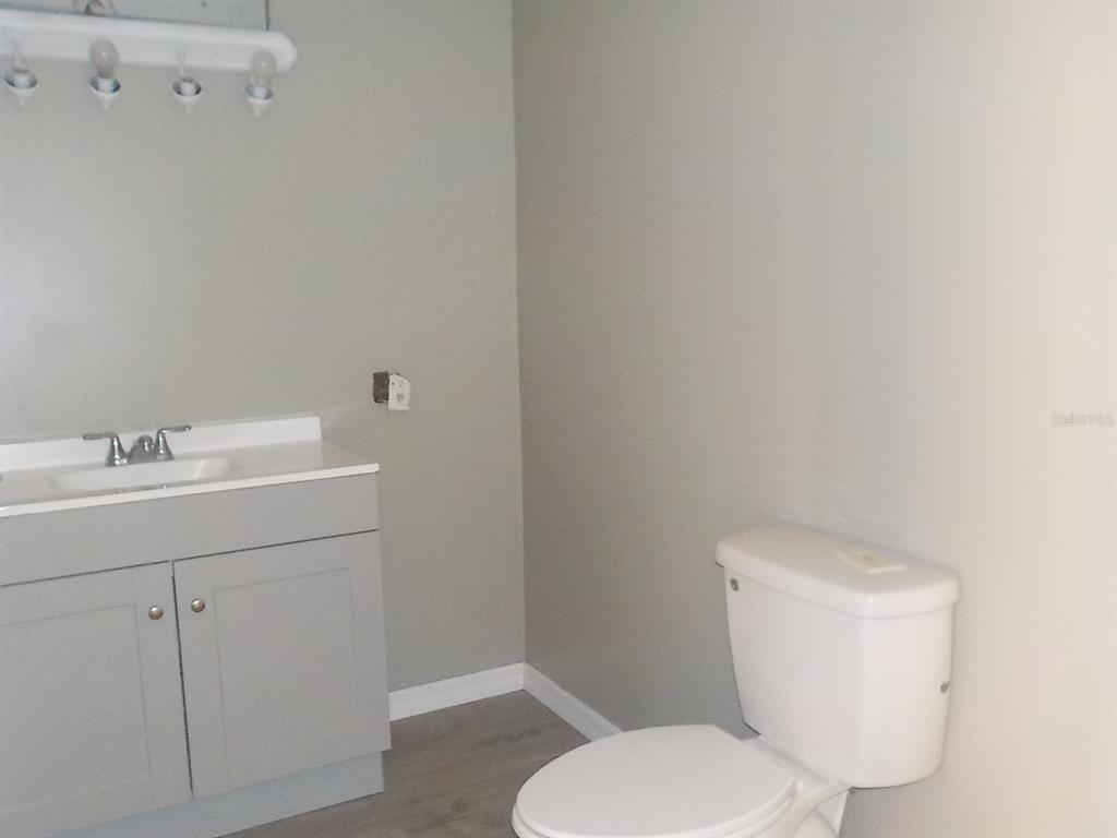 7445 Southwest 15th Place Ocala, FL 34474 - Photo 21 of 27 a white toilet sitting next to a bathroom sink