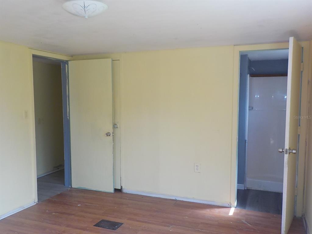 7445 Southwest 15th Place Ocala, FL 34474 - Photo 23 of 27 an empty room with wooden floor and closet