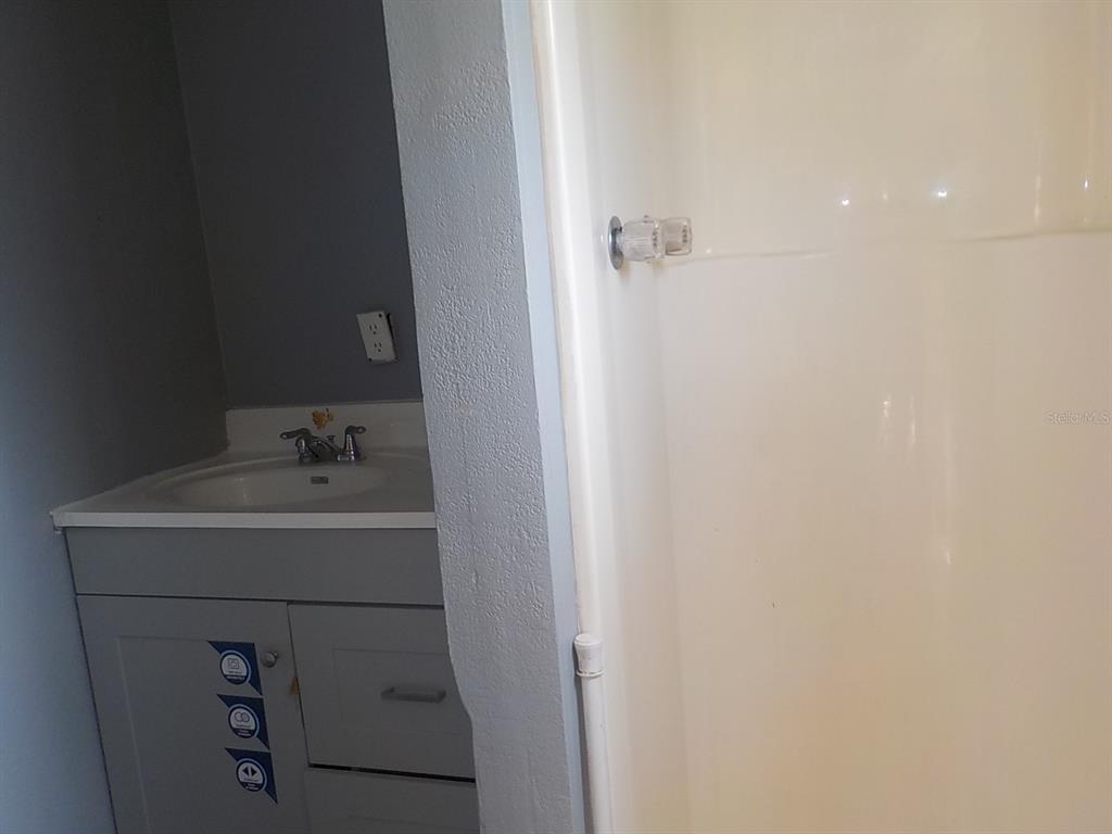 7445 Southwest 15th Place Ocala, FL 34474 - Photo 24 of 27 a bathroom with a sink and mirror