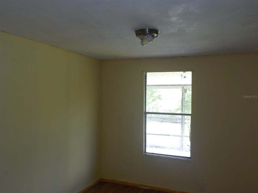 7445 Southwest 15th Place Ocala, FL 34474 - Photo 25 of 27 an empty room with a window