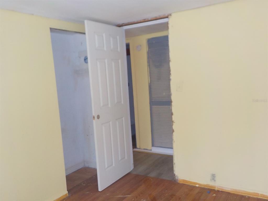 7445 Southwest 15th Place Ocala, FL 34474 - Photo 26 of 27 a view of a hallway with wooden floor