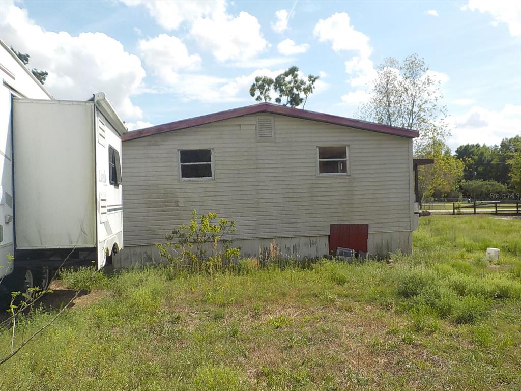 7445 Southwest 15th Place Ocala, FL 34474 - Photo 5 of 27 a backyard of a house with table and chairs