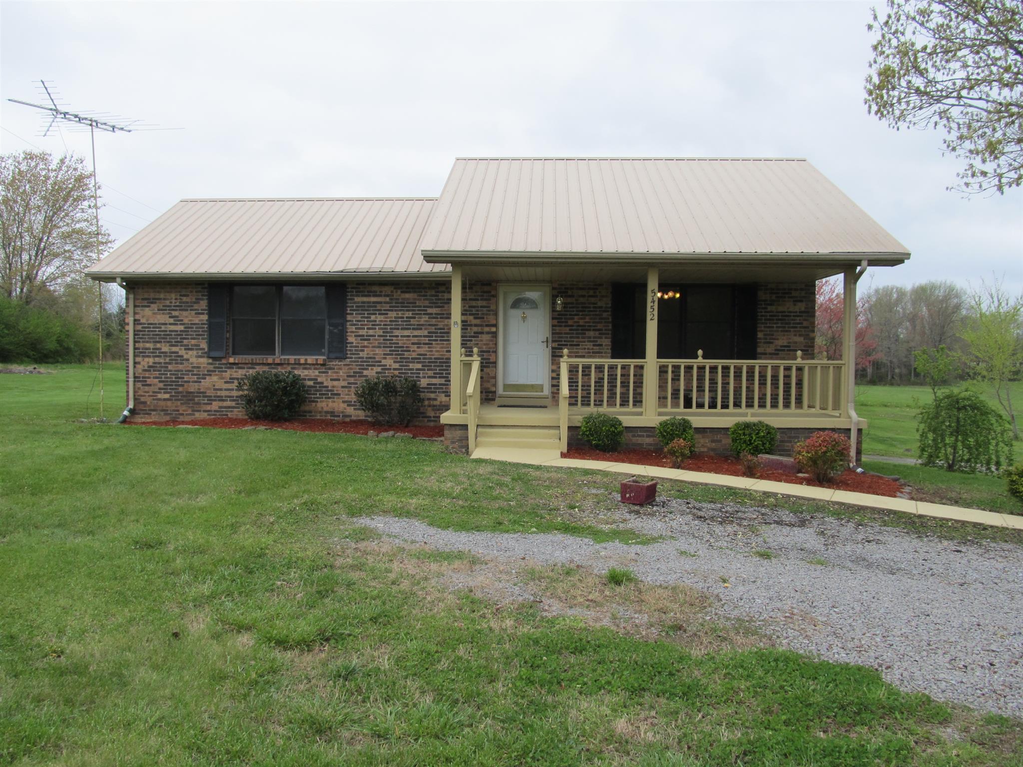 5452 Marion Road Cunningham, TN 37052 - Photo 1 of 15 a front view of a house with garden