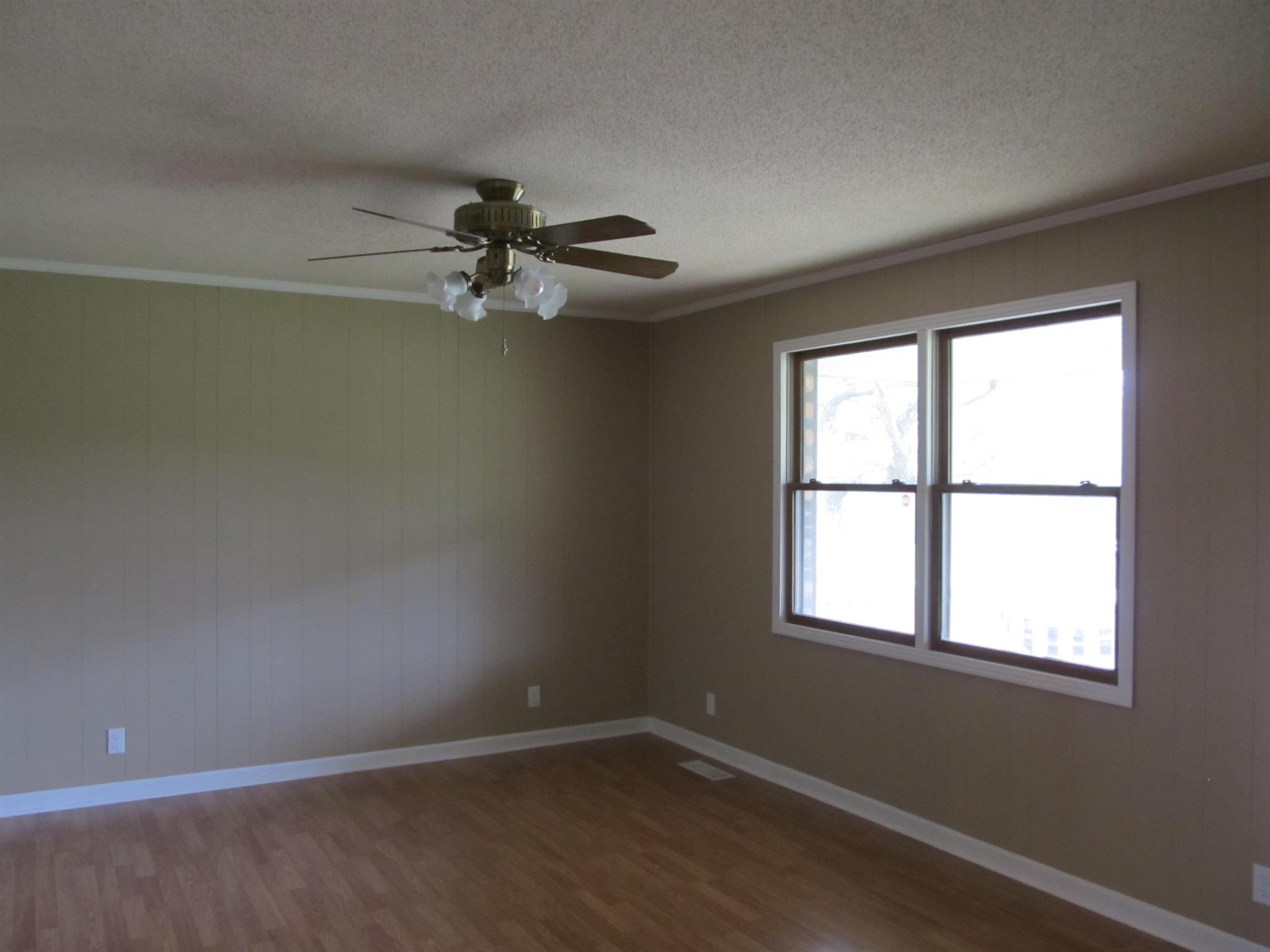 5452 Marion Road Cunningham, TN 37052 - Photo 3 of 15 an empty room with a window and a fan