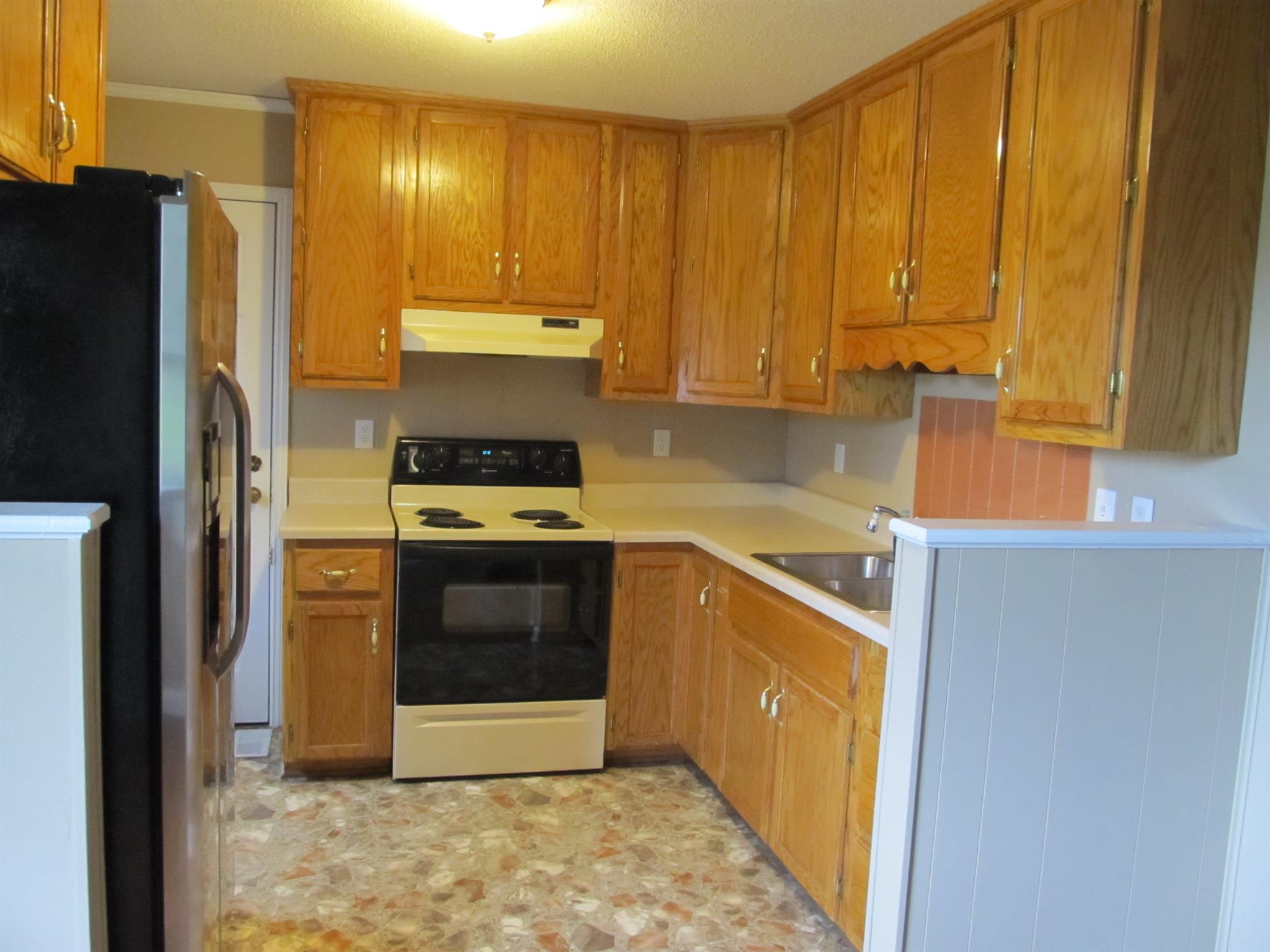 5452 Marion Road Cunningham, TN 37052 - Photo 5 of 15 a kitchen with stainless steel appliances a stove and a refrigerator