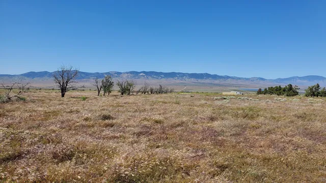 a view of a large building with mountains in the background