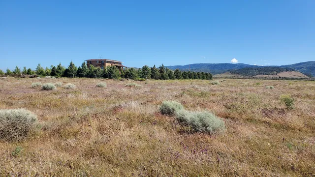 a view of mountain with sunset in background