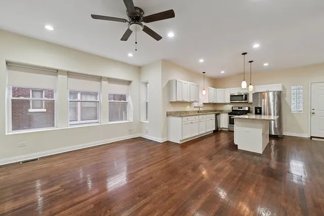 a view of kitchen with cabinets and wooden floor