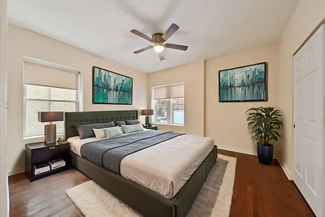 a bedroom with a bed and a painting on the wall