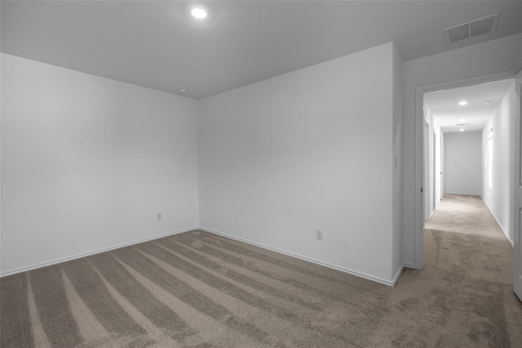 61 Trinity Circle Lockhart, TX 78644 - Photo 6 of 14 Carpeted room with white painted walls and recessed ceiling lighting