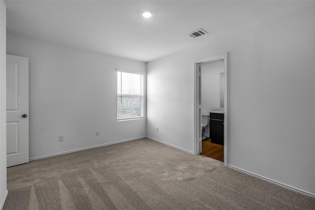 61 Trinity Circle Lockhart, TX 78644 - Photo 7 of 14 Carpeted room featuring a single window with blinds, white walls, and a ceiling light fixture