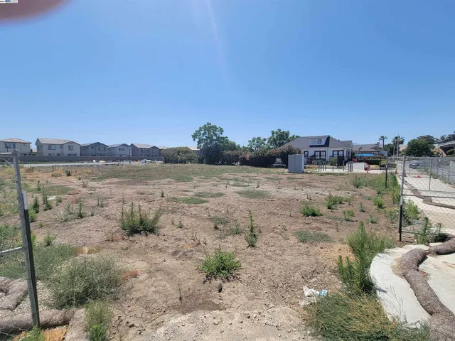 a view of a lake with houses in the back