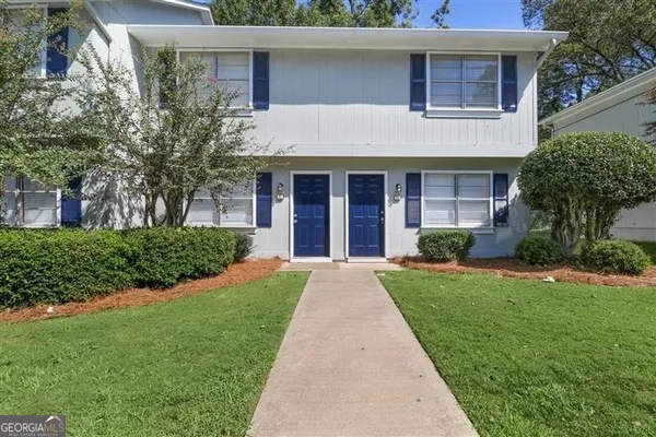 a front view of a house with a yard