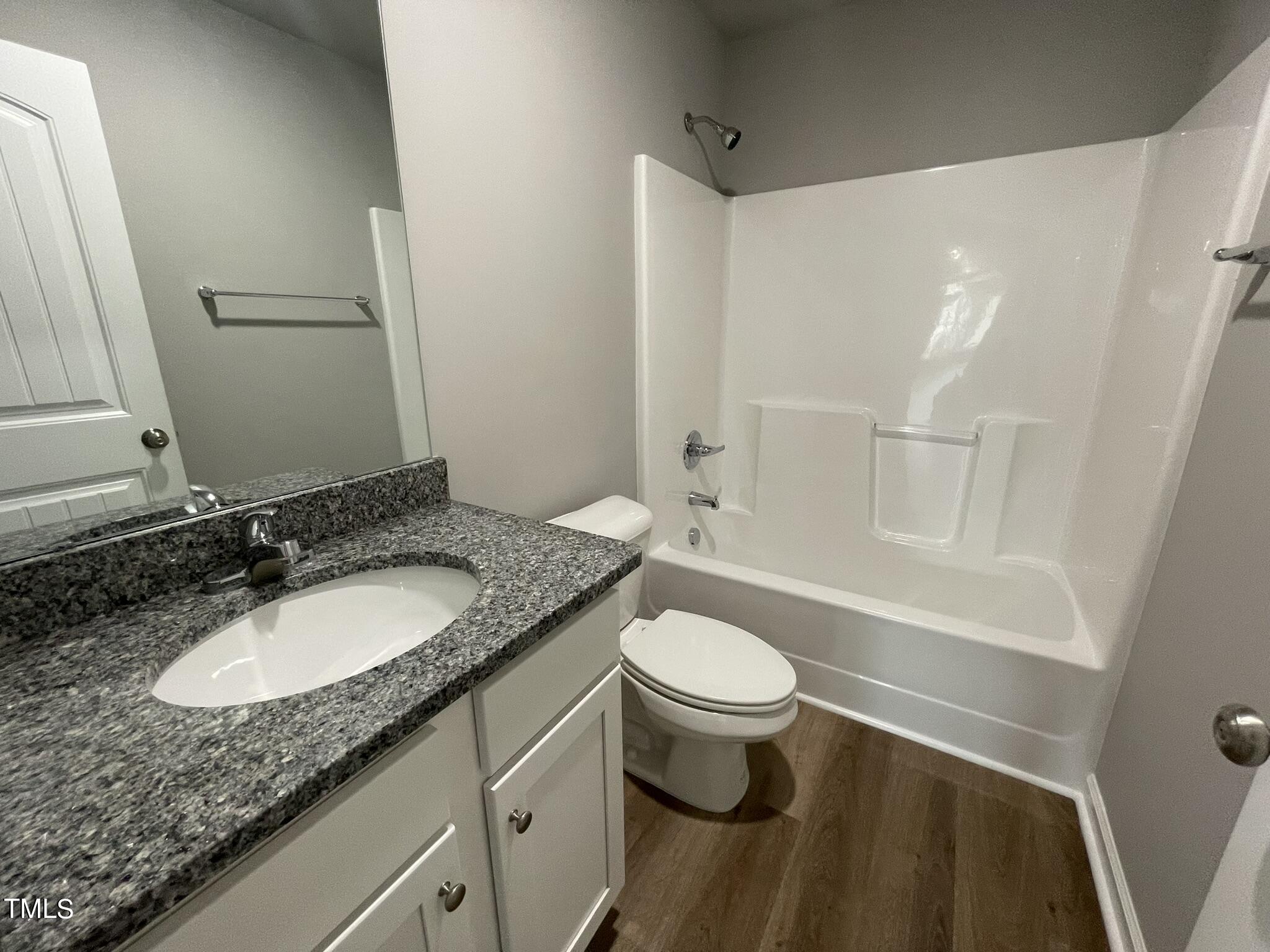 86 Scotties Ridge Drive Princeton, NC 27569 - Photo 14 of 19 a bathroom with a granite countertop sink toilet and a mirror