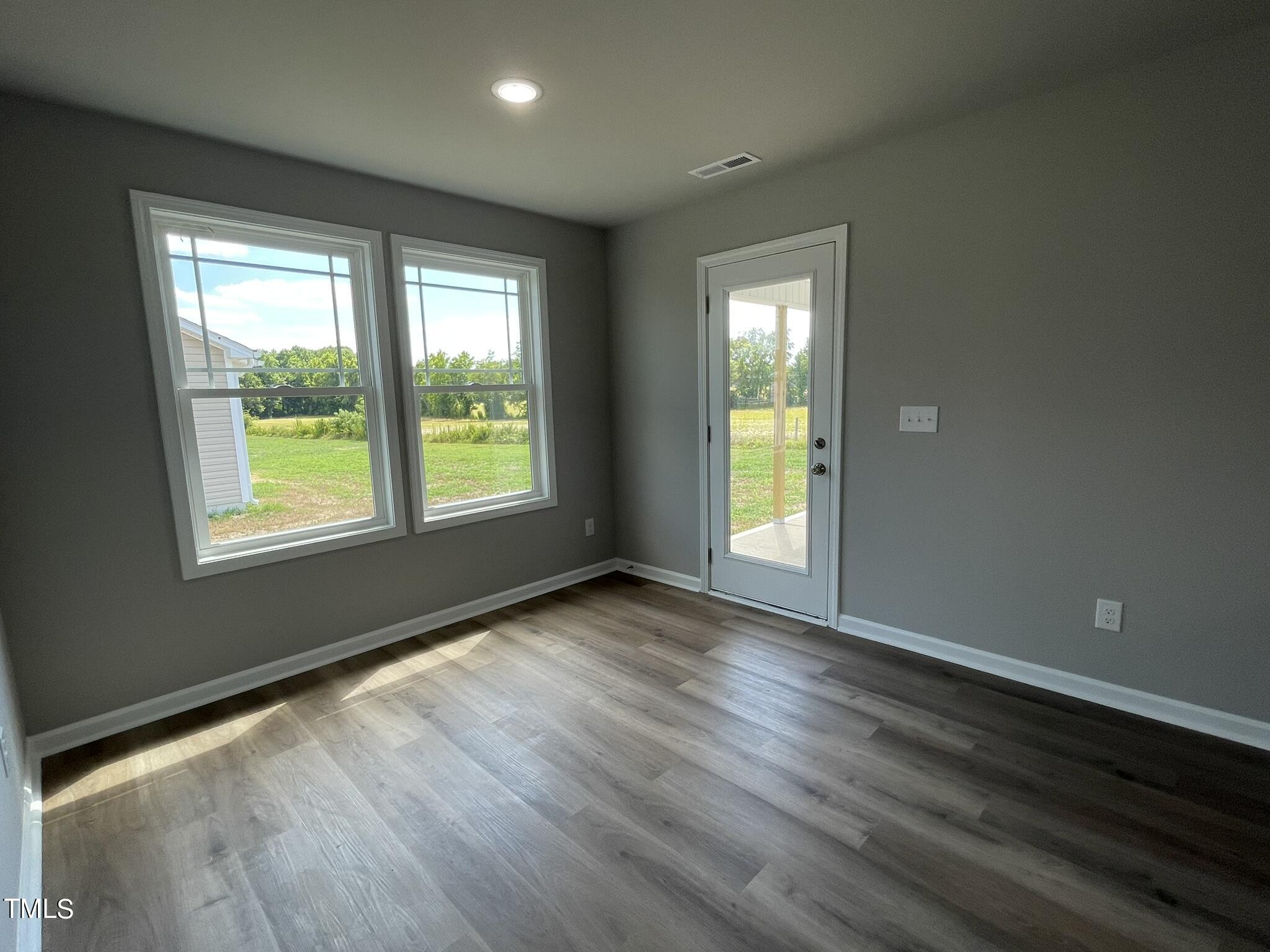 86 Scotties Ridge Drive Princeton, NC 27569 - Photo 5 of 19 a view of an empty room with wooden floor and a window