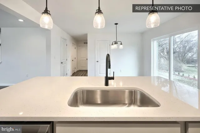 a kitchen with a sink a chandelier and chandelier