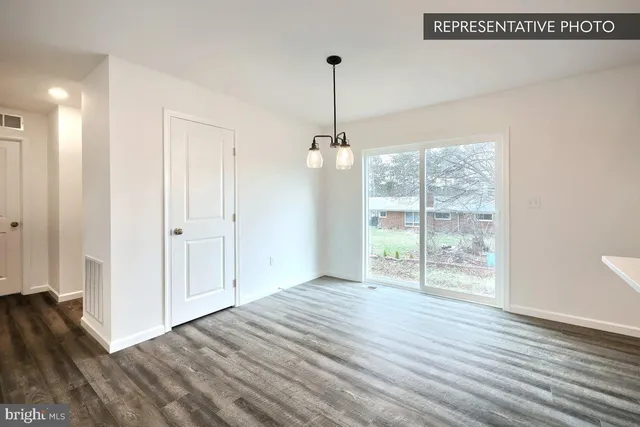 a view of hallway with wooden floor and window