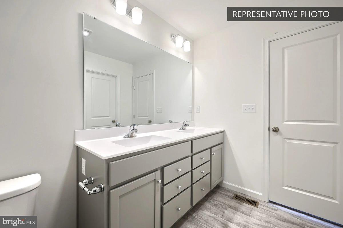 Pin Oak Plan At Hills Spring Grove, PA 17362 - Photo 28 of 38 a bathroom with a sink toilet and vanity