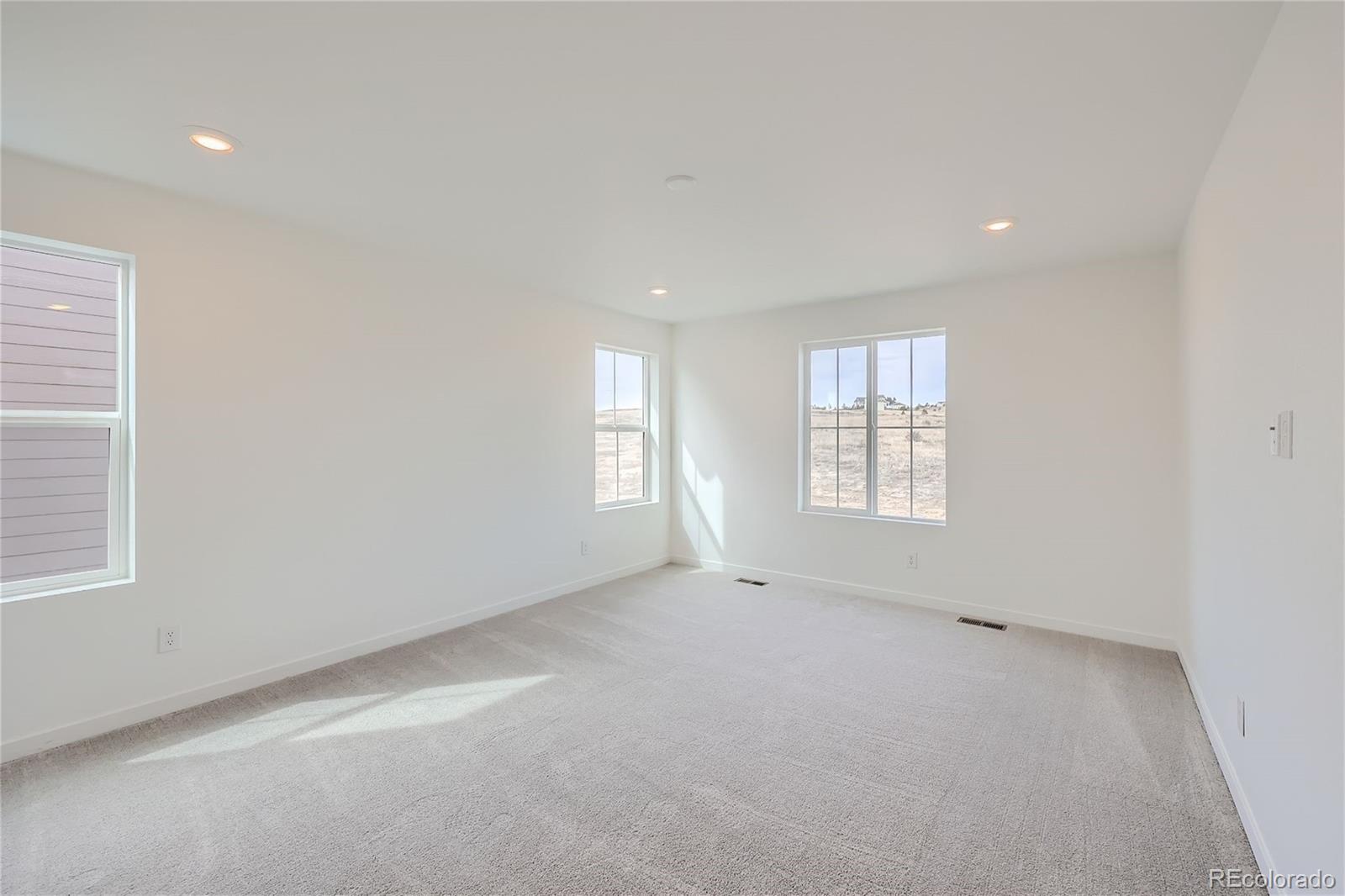 864 Yankee Boy Loop Elizabeth, CO 80107 - Photo 13 of 36 an empty room with windows